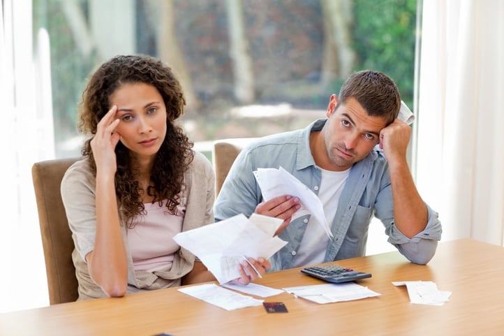 Young couple calculating their domestic bills at home